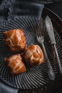 Kaboompics - Overhead Sweet Buns with Gray Napkin and Silverware