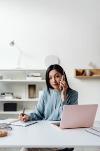 Kaboompics - Portrait of Asian Woman Taking a Phone Call at Her Desk