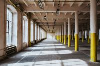 Kaboompics - Interior of an abandoned building hall with yellow pillars