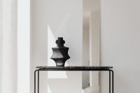 Kaboompics - Black Vase On Minimal Marble Console In Bright Interior