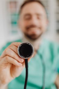 Kaboompics - Doctor Holding Stethoscope Chest Piece Toward Camera