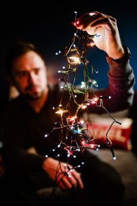 Kaboompics - Close-Up Christmas Lights with Blurred Man in the Background