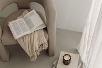 Kaboompics - Beige Reading Nook with Open Book and Sheer Curtains