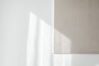 Kaboompics - Sunlit Beige Canvas Edge on a Minimal White Wall