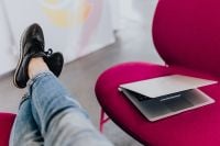Kaboompics - Woman using laptop computer and sitting cross legs on sofa