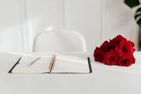 Kaboompics - Minimal February Planner and Red Roses on Bright Home Office Desk