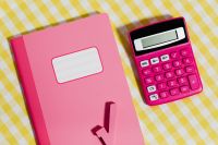 Kaboompics - Close-Up of a Pink Notebook and Calculator on Yellow Gingham