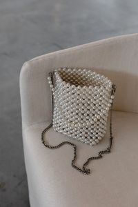 Kaboompics - Pearl Beaded Shoulder Bag on Cream Armchair