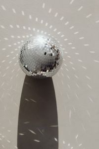 Kaboompics - Close-Up Mirror Ball with Circular Light Reflections and a Hard Shadow