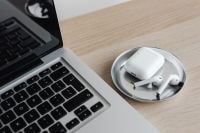 Kaboompics - Close-Up of Laptop and AirPods in Metal Dish