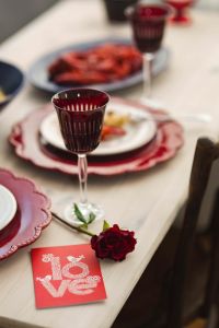 Kaboompics - Red Wine Glass with Rose and Elegant Seafood Dinner Setting