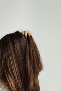 Kaboompics - Hand Resting on the Crown of Brown Hair, Minimal Beauty Portrait