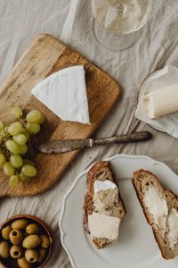 Kaboompics - Cheese Board With Grapes, Olives, and Bread
