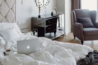 Kaboompics - Macbook, an iPhone, a coffee, a chocolate and a notebook in a bed