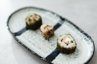 Kaboompics - Three Assorted Maki Rolls on a Textured Ceramic Sushi Plate