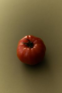 Kaboompics - Red Tomato on Olive Green Background