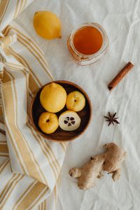 Kaboompics - Japanese Quince and Lemon Still Life with Honey, Cinnamon, Star Anise and Ginger on Linen