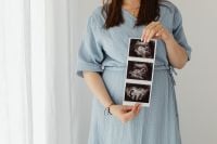 Kaboompics - Pregnant Woman Holding Ultrasound Photos