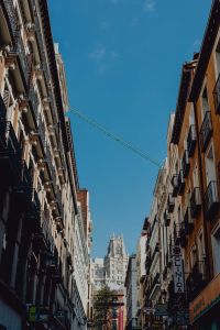 Kaboompics - Vertical View Up a Madrid Street Canyon with Crane and Iron Balconies