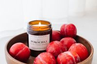 Kaboompics - Soy Candle Product Still Life with Fresh Red Plums for Minimalist Home Decor