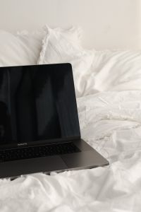 Kaboompics - Laptop for a Calm Work From Bed Setup in a Neutral Bedroom