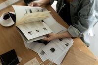 Kaboompics - Designer Reviewing Furniture Catalog with Laptop and Interior Moodboard