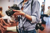 Kaboompics - Woman holding a black camera