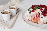 Kaboompics - Meringue Pavlova with a Missing Slice and Two White Coffee Cups