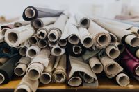 Kaboompics - Assorted Upholstery Fabric Rolls in Neutral, Charcoal and Burgundy Tones