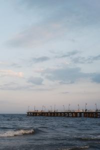 Kaboompics - Coastal Pier and Waves Under Cloudy Summer Sky
