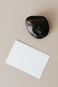 Kaboompics - Blank Card Mockup with Polished Black Stone on Beige
