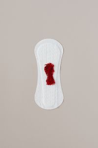 Kaboompics - Minimal Menstrual Care Concept with Sanitary Pad and Crimson Fabric