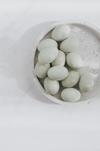 Kaboompics - Easter flat lay with green eggs on a white marble