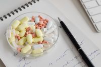 Kaboompics - Colorful Tablets Beside Notebook and Computer Keyboard