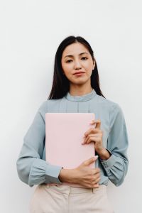 Kaboompics - Portrait of an Asian Woman Holding a Pink Laptop