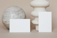 Kaboompics - Two Blank Business Cards with Stone Sphere and White Sculptural Vase, Minimal Stationery Mockup