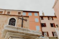 Kaboompics - Weathered Metal Cross with Pastel Buildings in Rovinj, Croatia