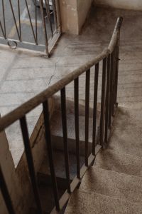 Kaboompics - Rusted Metal Stair Railing over Terrazzo Landing