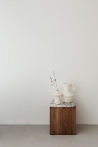 Kaboompics - Minimalist White Vases on Wooden Side Table beside Upholstered Chair