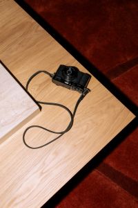 Kaboompics - Minimal Living Room Scene With Camera On Wooden Coffee Table