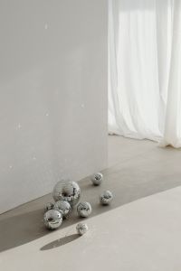 Kaboompics - Cluster of Mirror Balls by a Sheer Curtain with Open Wall Space
