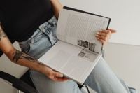Kaboompics - Close-Up of an Open Book Held on a Woman's Lap
