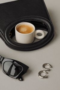 Kaboompics - Black Handbag, Black Boots, Espresso and Sunglasses Flat Lay