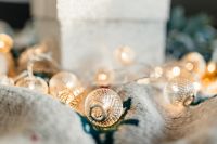 Kaboompics - White Christmas Present with Golden Fairy Lights