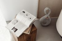 Kaboompics - Open Book Still Life with Walnut Side Table and Sculptural Decor