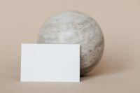Kaboompics - Horizontal Blank Business Card in Front of Textured Stone Sphere, Beige Minimal Branding Mockup