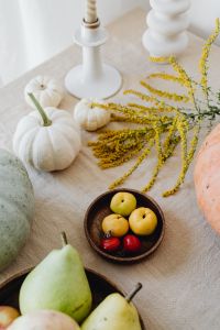 Kaboompics - Pumpkins, Goldenrod, White Vase and Coffee on Beige Linen, Vertical Autumn Table Styling