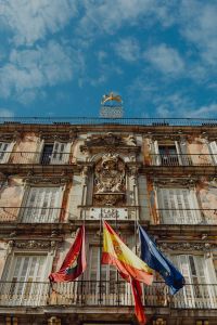 Kaboompics - Ornate Plaza Mayor Facade and Flags Under Madrid Sky
