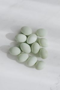 Kaboompics - Easter flat lay with green eggs on a white marble