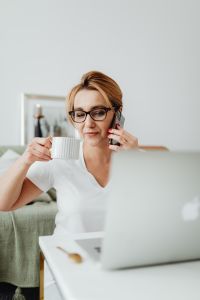 Kaboompics - Sipping Coffee While Taking a Phone Call in a Relaxed Home Office
